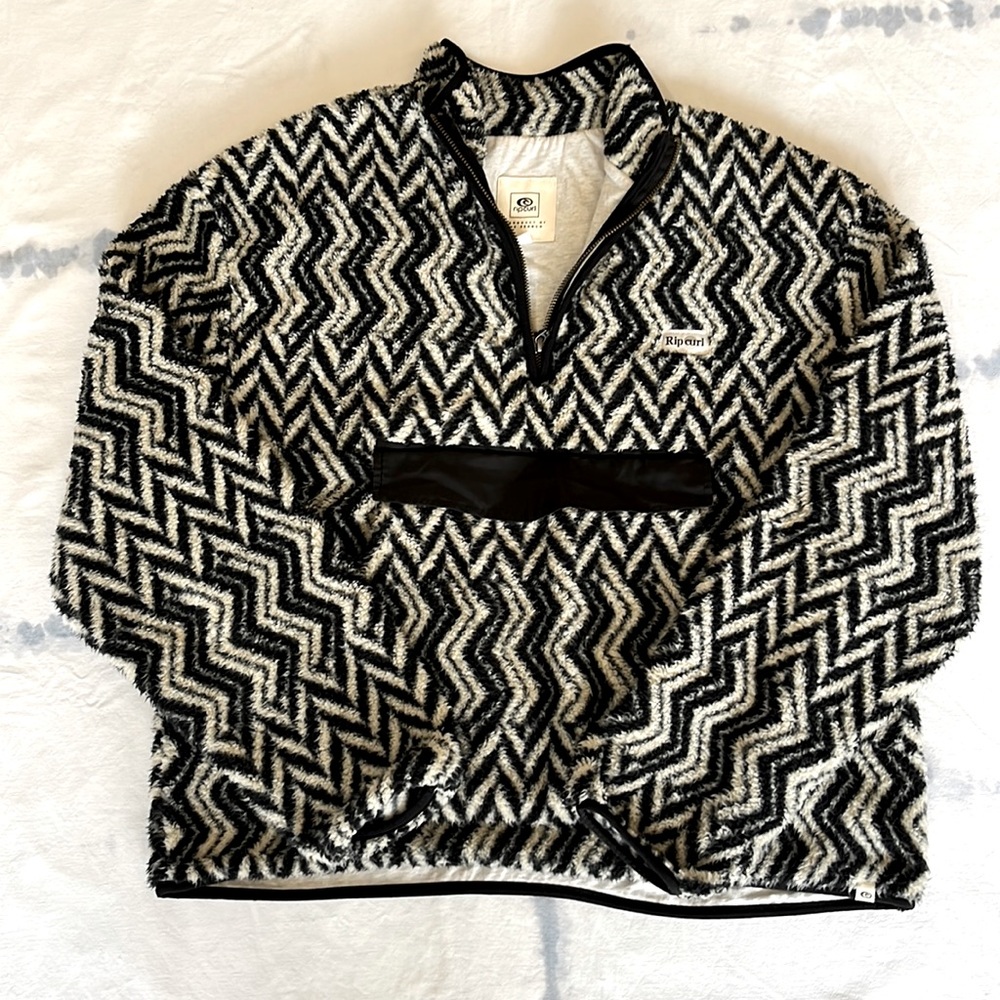 Great condition. Rip curl black and cream fuzzy 1/4 zip jacket. Pouch pocket!
